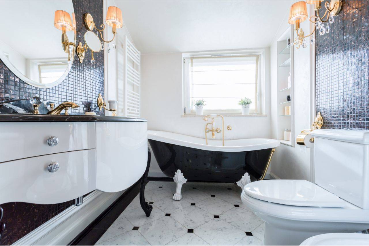A modern bathroom with a black claw foot tub and floating vanity.