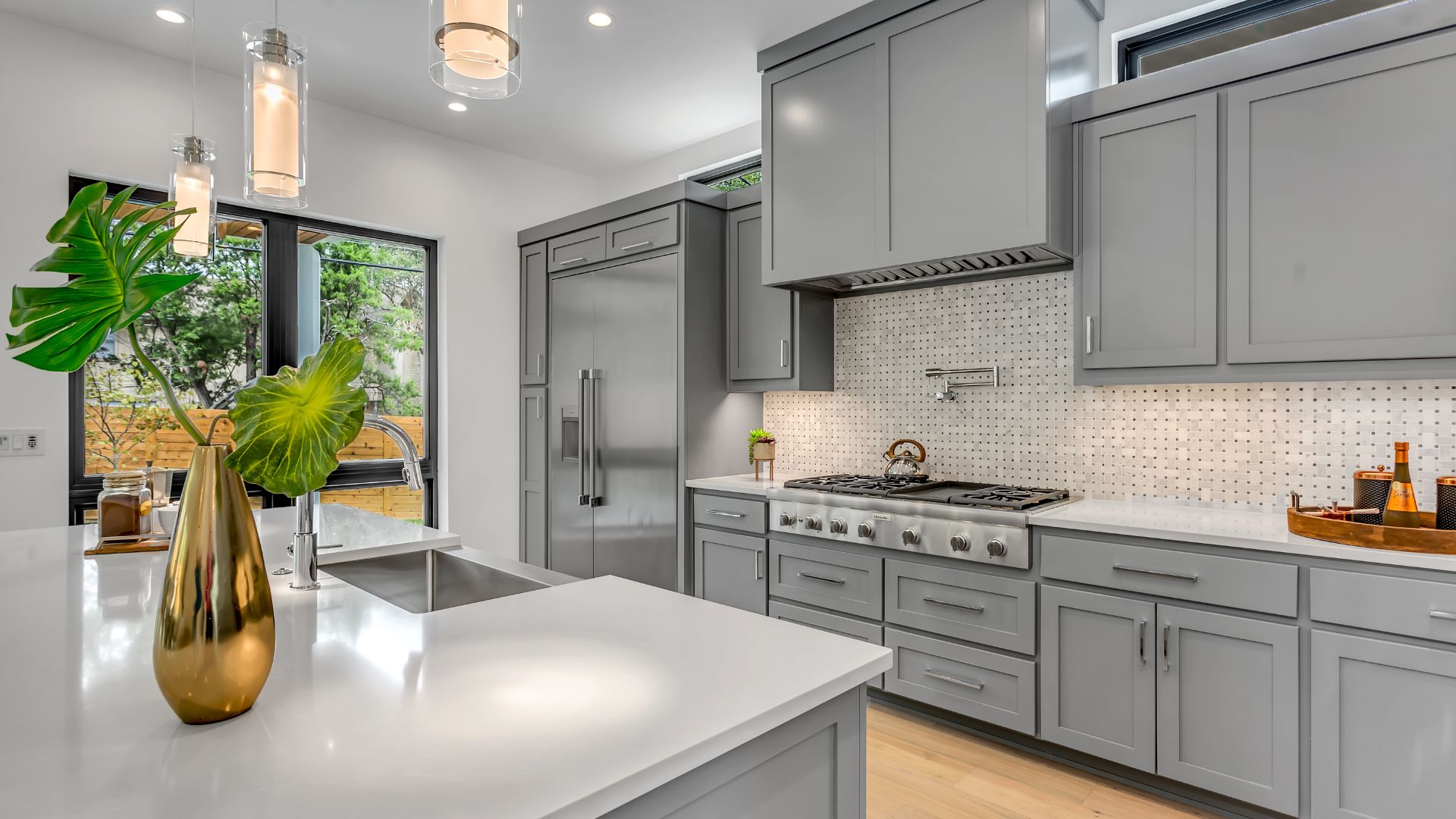 A modern kitchen with gray cabinets.